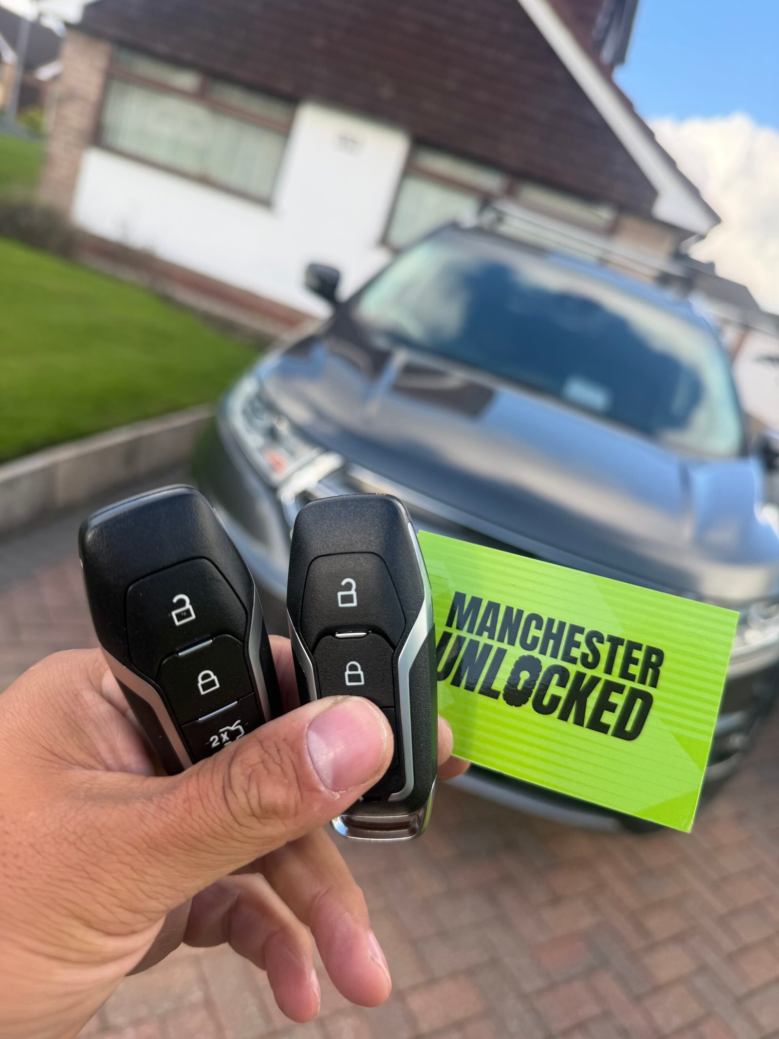 Two Ford keys held in front of the 2018 Ford Edge during the WN5 Wigan job