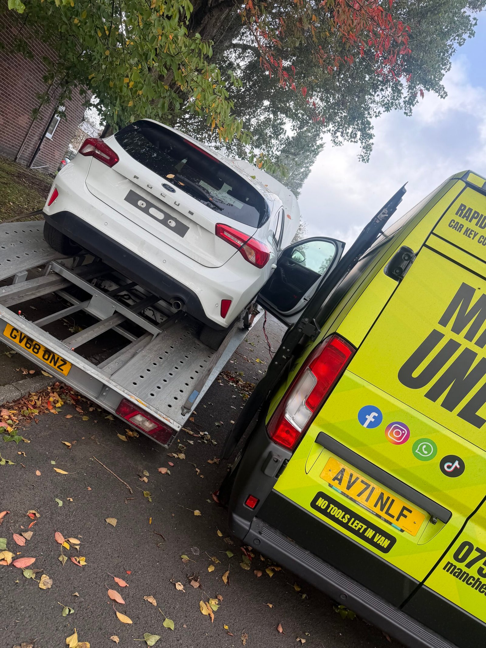 Rear of the Ford Focus on a transporter beside the Manchester Unlocked van