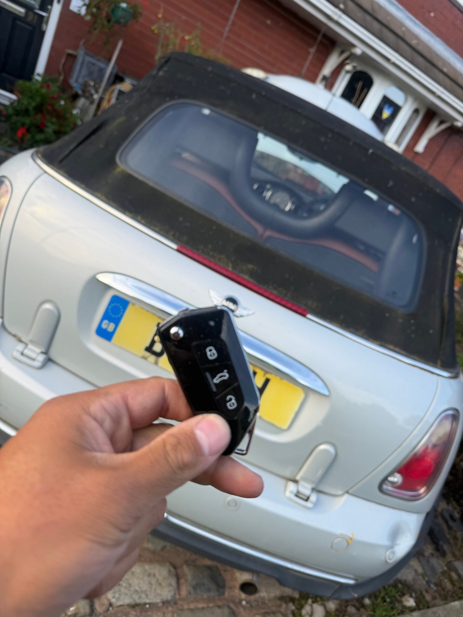 New key held in front of the 2006 MINI convertible during the Wigan key replacement job