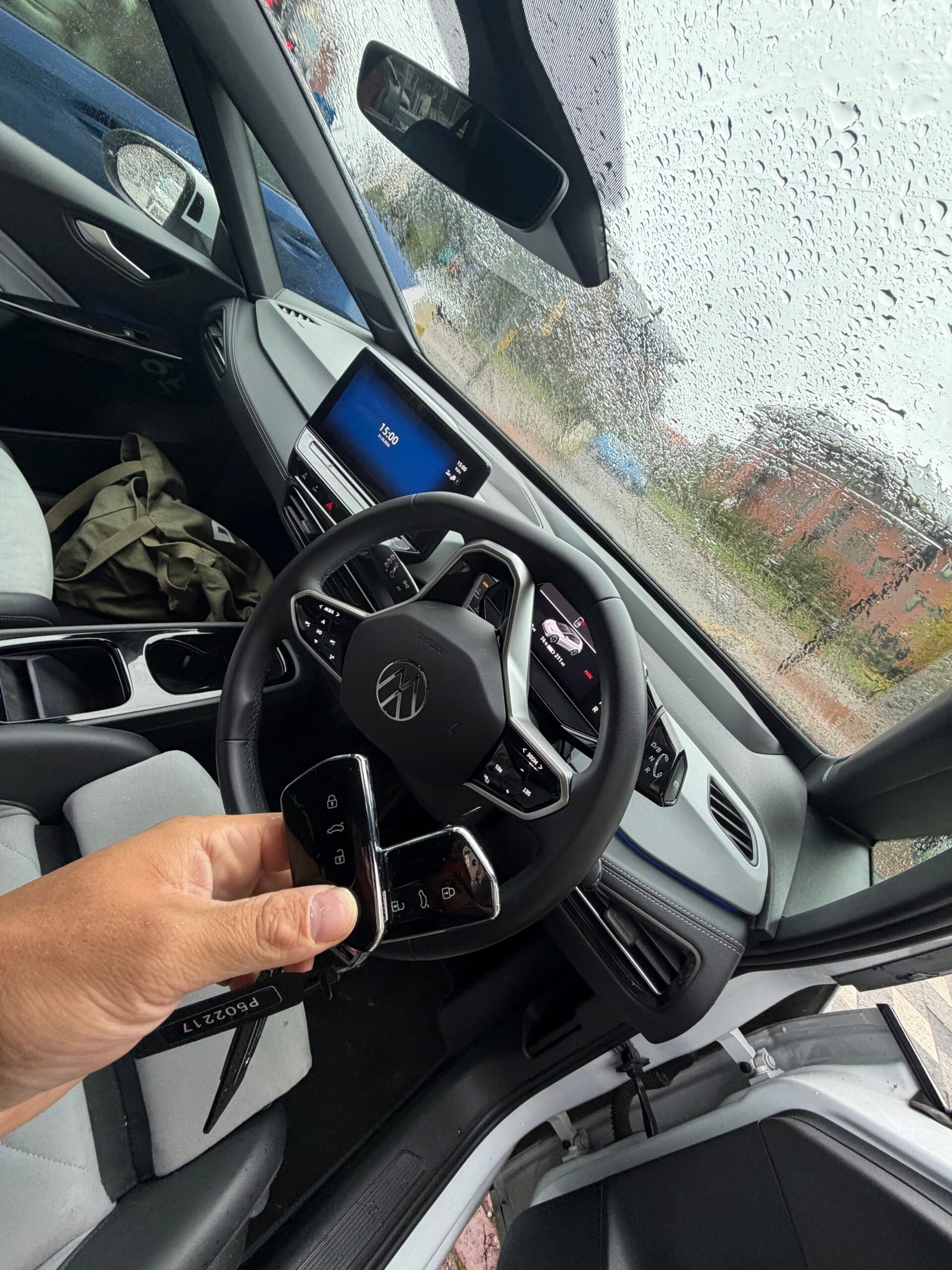 Volkswagen ID.3 keys held beside the steering wheel inside the electric car